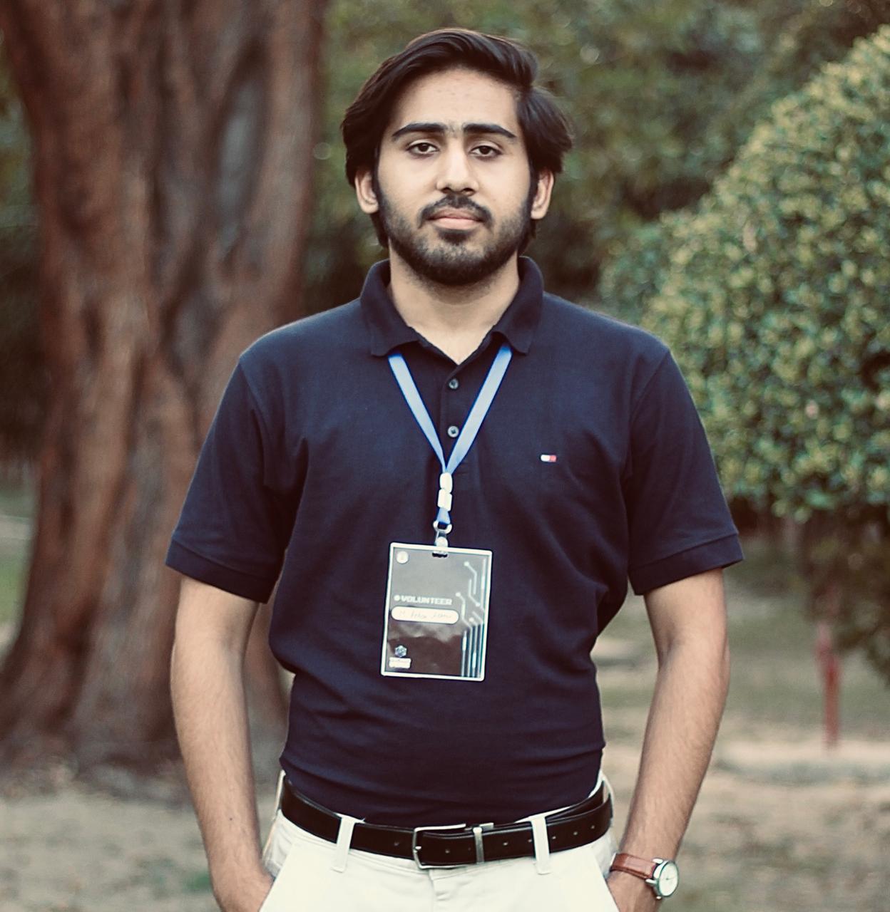 Husnain smiling in a typical plain black designer t-shirt